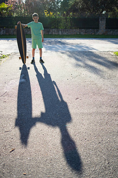 Teenage group of skater friends standing together at sunset