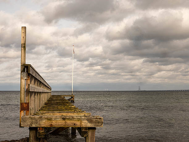 istock Jetty by the Sea in Denmark with Unique Structure and Dramatic Clouds 2209166128