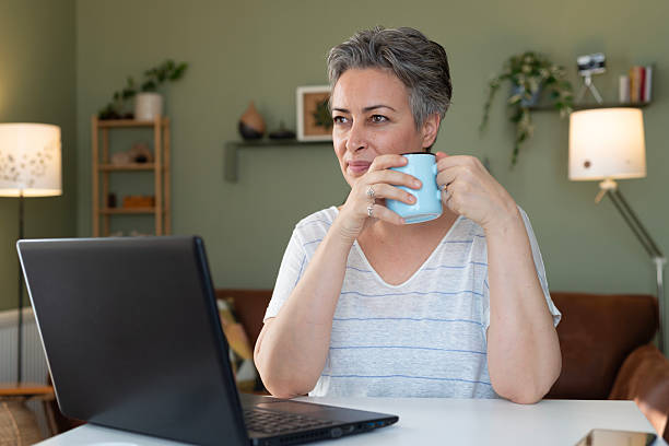istock Woman using laptop at home 2209166927