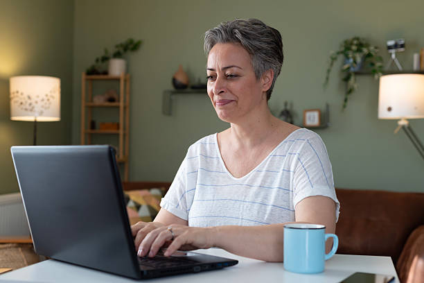 istock Woman using laptop at home 2209166998