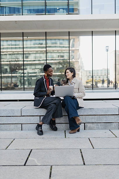 istock Two women discussing work outside a modern building 2209167050