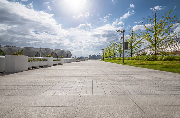 istock Empty stone tile walkway and skyline in a modern city park. 2209169559