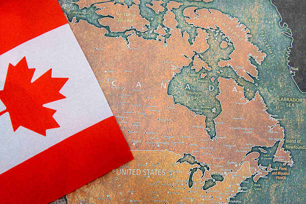 istock Canada national flag on the paper world map. 2209170974
