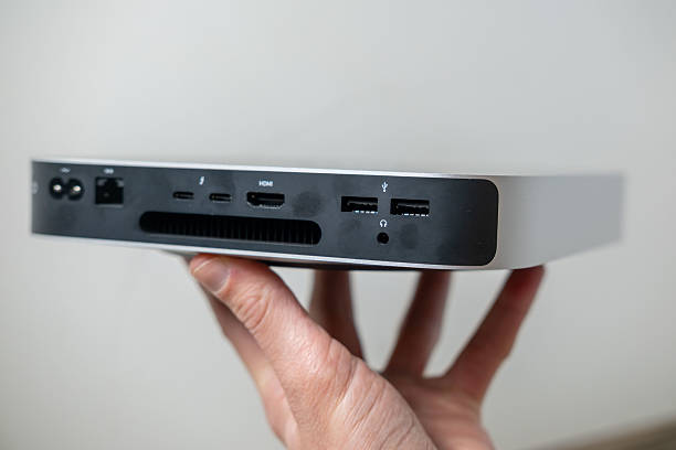 istock Mini computer held in male hands, ports portable computer, tech portability, working remotely in cozy home environment, home setup, remote job, downshifting lifestyle 2209171033