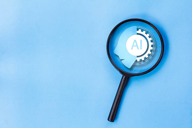 istock Magnifying glass focus on AI icon, concept of learning to use AI 2209171346