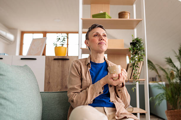 istock Woman relaxing at home and drinking coffee 2209173154
