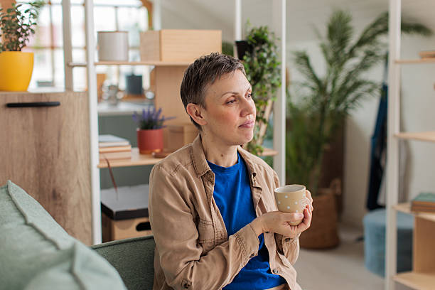 istock Woman relaxing and drinking coffee at home 2209173462