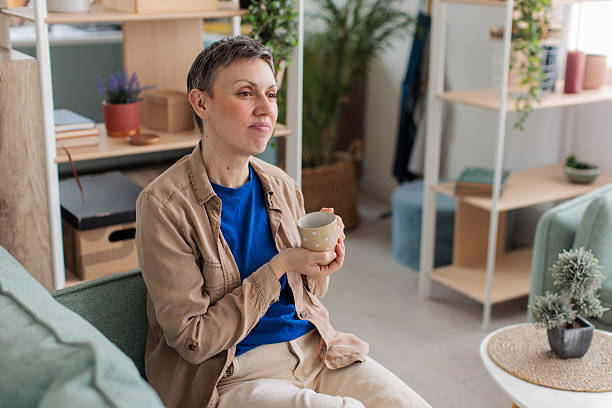 istock Woman relaxing and drinking coffee at home 2209173499