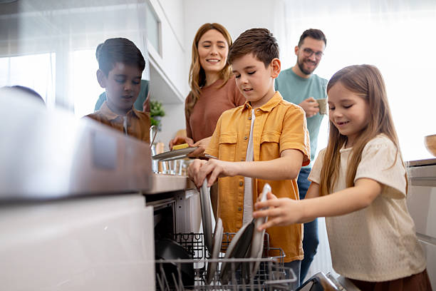 istock Kids helping with chores in modern kitchen 2209174053