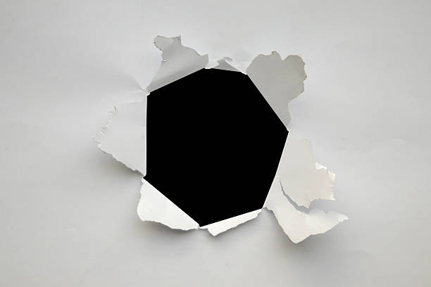istock Torn ripped paper hole isolated on black background 2209174302