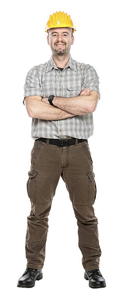 istock Confident construction worker smiling with arms crossed on white background 2209174713