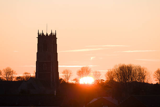 Church tower at sunset in winter on the Norfolk coast. East Somerton, Norfolk, UK