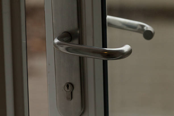istock Closeup view featuring a modern door handle along with its lock mechanism 2209177108