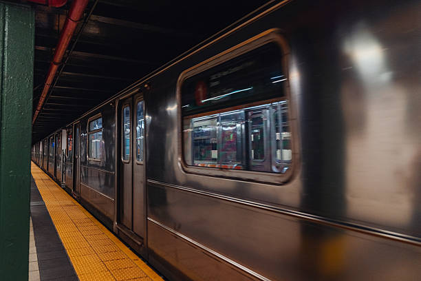 istock New York subway, train arriving, empty station, people waiting for the train 2209177235