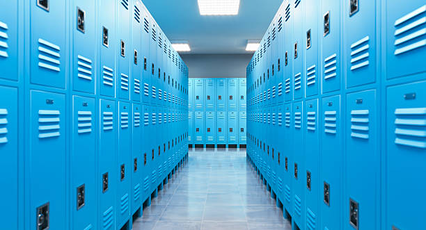 Empty school hallway with rows of blue lockers extending into the distance