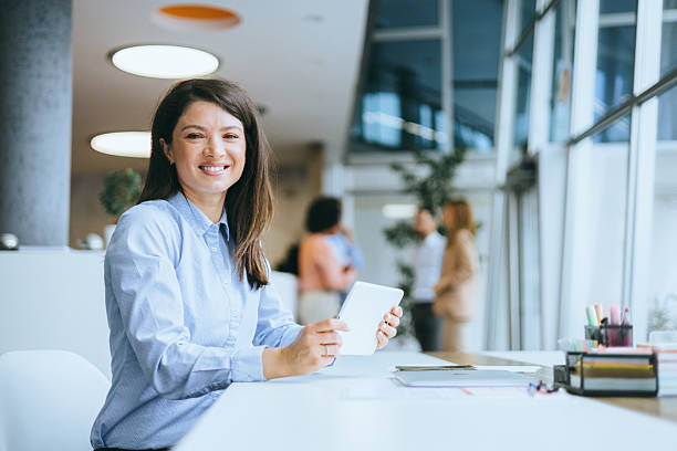 istock Smiling businesswoman holding a tablet 2209178911