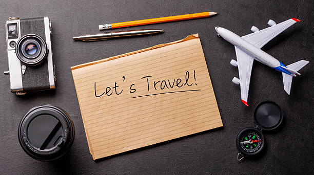 istock Creative flat lay of a travel-themed desk with notepad for plans 2209179835