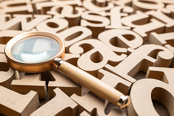 A magnifying glass placed on the English alphabets