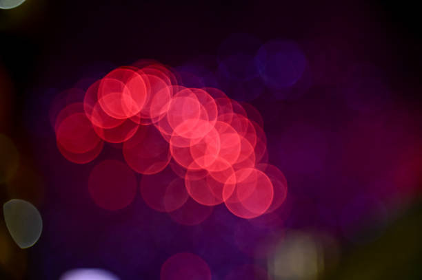 Bokeh effect of colorful fireworks display in the night sky. Real fireworks background.  Abstract of real shining fireworks against black background. Glowing fireworks show for celebration.