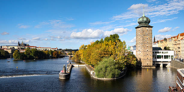 Panoramic Cityscape View Of Prague With The Vltava River, Historic Architecture, And Urban Skyline, Captured From A Public Viewpoint.