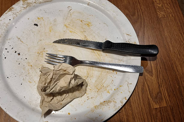 istock Used Dinner Plate with Cutlery on Wooden Table - Post-Meal Cleanup Concept 2209181061