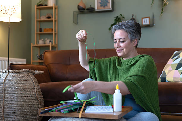 istock Woman doing hobby work with papers at home 2209181532