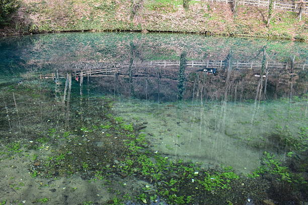 A stunning view of the Blautopf, a natural spring in Blaubeuren, Germany, known for its incredibly deep turquoise-blue water. Nestled at the foot of the Swabian Alps and next to the historic Blaubeuren Abbey, this enchanting spring is surrounded by legends and serene landscapes. Ideal for nature content, travel videos, or footage capturing the mystical beauty of Germany’s natural wonders.