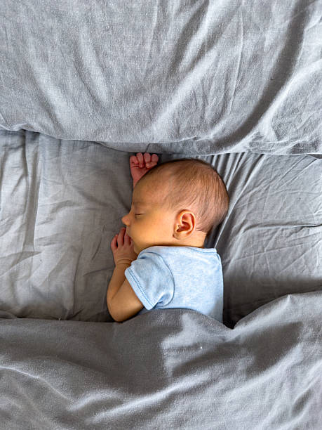 istock Newborn Baby Sleeping Peacefully on Bed 2209181838