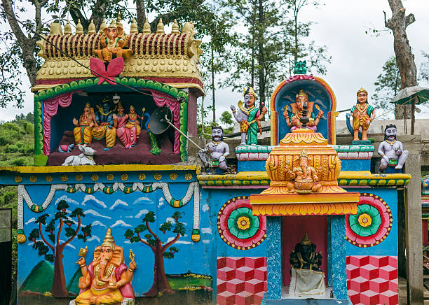 Vibrant Hindu shrine adorned with statues and paintings of deities, nestled in the lush landscapes of Sri Lanka's hill country