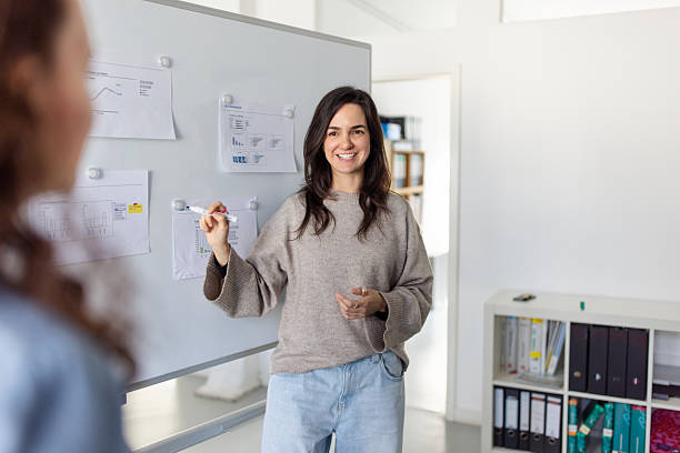 istock Manager discussing marketing ideas with team at office 2209182463