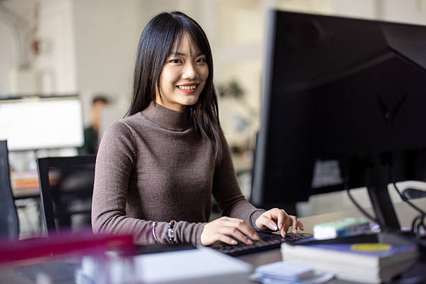 istock Smiling businesswoman working at her desk 2209182621