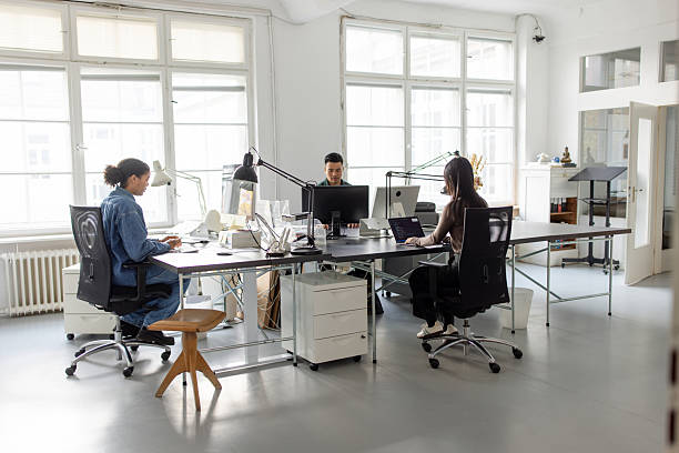 istock Open plan office with people working at coworking desk 2209182828