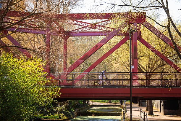 London, UK - 2 April, 2025: people on a red bridge in Shadwell Basin, in the Wapping area of London.
