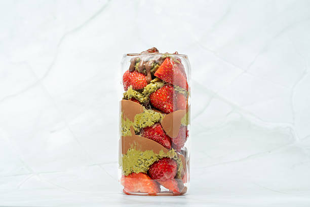 Dubai chocolate strawberry cup with kataifi, pistachio paste, milk chocolate and fresh strawberries. Street food desserts and sweets. Copy space for text.