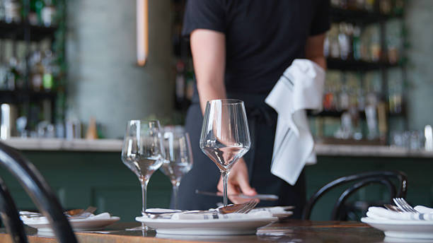 istock Close Up Of Male Server Laying Place Setting On Restaurant Table 2209185006