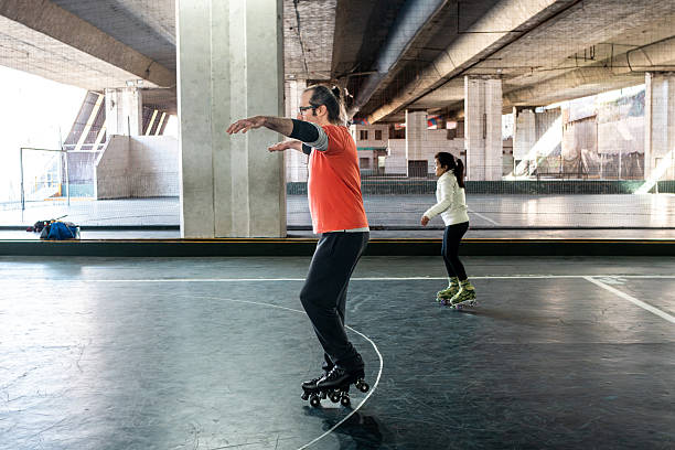 istock Mature man with visual impairment skating with roller skates at the court 2209185020