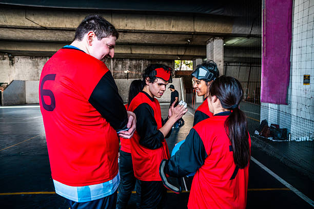 Visually impaired handball team talking at sport court