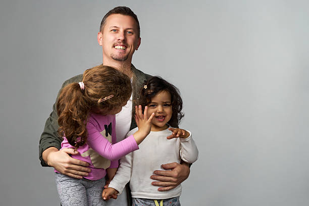 father's caring eyes and the child's contentment speak volumes about their strong bond and the simple joys of parenting