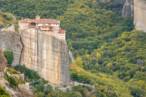 Mountains of Thessaly in Northern Greece. Christian monastery on top of a cliff surrounded by green forest