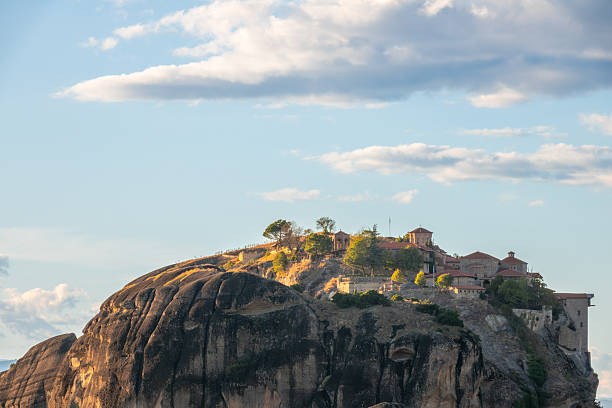 Mountains of Thessaly in Northern Greece. Christian monastery on top of a rock in Meteora and blue sky with light clouds