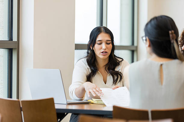 istock Hispanic Woman Explains Documents to Two Colleagues During a Meeting 2209187568