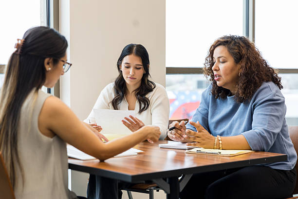 istock Three Diverse Women in a Business Meeting, Discussing Documents 2209187592