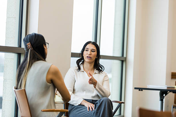 istock Two Women in Casual Clothing Having a Discussion 2209187603