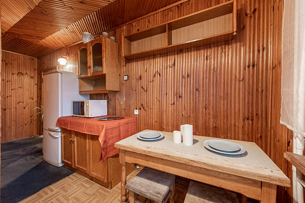 istock Rustic Small Kitchen Interior with Wooden Walls and Compact Dining Area 2209188187
