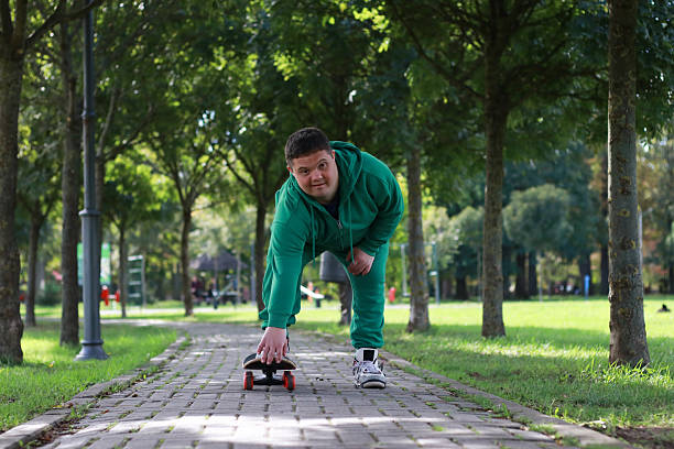 Disability Down syndrome young man positive emotions active healthy