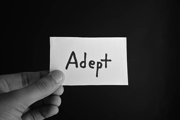 istock Hand holding a paper card with the word ADEPT 2209191962