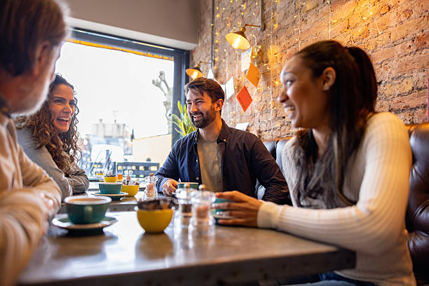 istock Happy friends laughing while having coffee at a cafe 2209194683