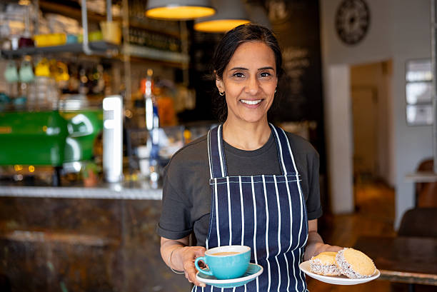 istock Waitress serving food at a coffee shop 2209194701