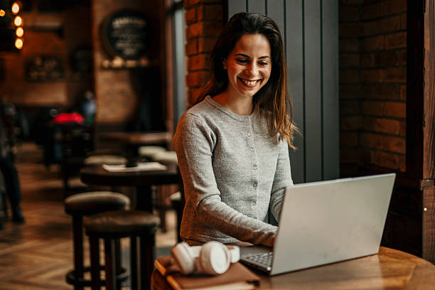 istock Young Woman Working on Laptop in a Cafe 2209195500