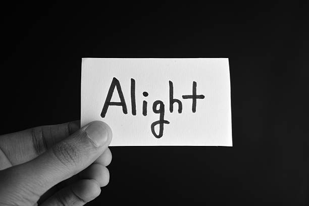 istock Hand holding a paper card with the word ALIGHT 2209195598